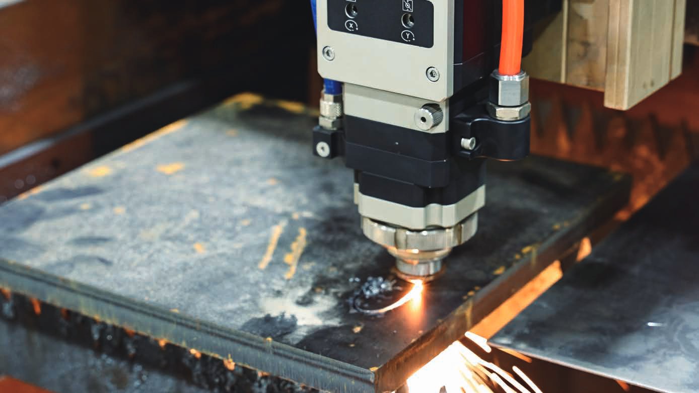 BLT laser head cutting steel close up — showing precision nozzle and focus